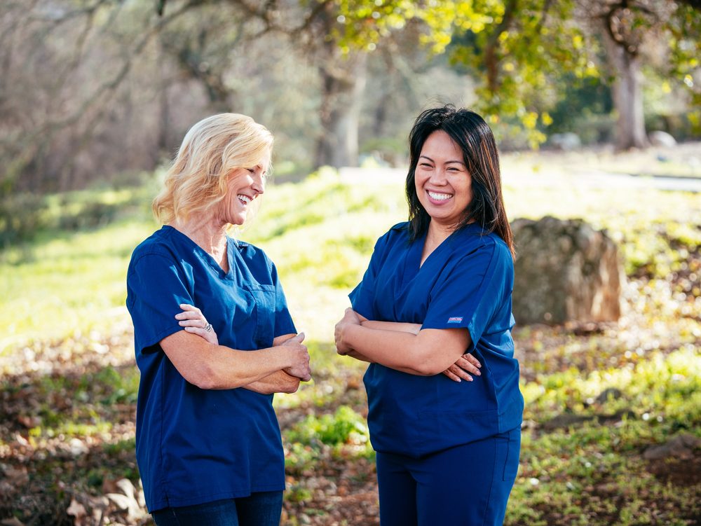 Karen Silcox and Beryl Abelardo, the registered nurses who co-founded Golden Connect In-Home Care, smiling together outdoors